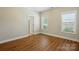 A vacant bedroom with hardwood floors and ample natural light at 7903 Tottenham Ct, Waxhaw, NC 28173