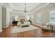 Spacious bedroom with hardwood floors, chandelier, and tray ceiling at 7903 Tottenham Ct, Waxhaw, NC 28173