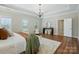 A well-lit bedroom with a tray ceiling and a view of the en suite at 7903 Tottenham Ct, Waxhaw, NC 28173