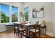 Bright breakfast nook features a banquette, wood table, and natural light from the windows at 7903 Tottenham Ct, Waxhaw, NC 28173