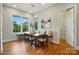 Bright breakfast nook features a banquette, wood table, and natural light from the windows at 7903 Tottenham Ct, Waxhaw, NC 28173