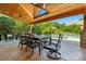 Outdoor dining area with a ceiling fan and comfortable seating under a covered patio with a view of the pool at 7903 Tottenham Ct, Waxhaw, NC 28173