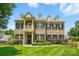 Elegant two-story brick home with manicured lawn, tasteful landscaping, and classic architectural details at 7903 Tottenham Ct, Waxhaw, NC 28173