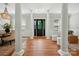 Grand foyer showcasing elegant columns, natural light, and a detailed front door at 7903 Tottenham Ct, Waxhaw, NC 28173
