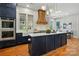 Kitchen featuring navy cabinets, stainless appliances, a large island, and a custom range hood at 7903 Tottenham Ct, Waxhaw, NC 28173