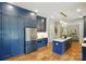 Kitchen with blue cabinets, stainless appliances, and a view into the living room at 7903 Tottenham Ct, Waxhaw, NC 28173