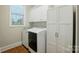 Clean laundry room equipped with modern appliances and ample storage at 7903 Tottenham Ct, Waxhaw, NC 28173