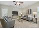 Cozy living room with a ceiling fan and comfortable seating arrangement at 7903 Tottenham Ct, Waxhaw, NC 28173
