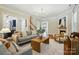 Open-concept living room with fireplace, stylish decor, and a smooth transition to adjacent rooms at 7903 Tottenham Ct, Waxhaw, NC 28173