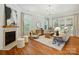 Inviting living room with fireplace, hardwood floors, neutral tones, and ample natural light at 7903 Tottenham Ct, Waxhaw, NC 28173