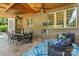 Covered patio with brickwork, stamped concrete flooring, outdoor seating, and ceiling fans for comfortable outdoor living at 7903 Tottenham Ct, Waxhaw, NC 28173