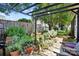 Inviting backyard garden area, featuring a pergola, lush plants, and a stone pathway at 805 Caldwell St, Belmont, NC 28012