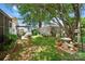 Lush backyard with green grass, mature trees, and privacy fence offers a serene outdoor escape at 805 Caldwell St, Belmont, NC 28012