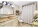 Cozy bathroom with tiled floors, under sink storage, and decorative elements at 805 Caldwell St, Belmont, NC 28012