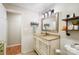 Well-lit bathroom features a vanity with storage, stylish mirror, and decorative shelving for a charming touch at 805 Caldwell St, Belmont, NC 28012