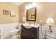 Cozy bathroom with vanity, framed mirror, toilet, and wainscoting offers a practical and inviting space at 805 Caldwell St, Belmont, NC 28012