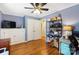 Spacious bedroom with hardwood flooring, a ceiling fan, and built-in storage offers versatility and comfort at 805 Caldwell St, Belmont, NC 28012