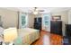 Bedroom with two large windows, wood-look flooring, and ceiling fan at 805 Caldwell St, Belmont, NC 28012
