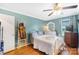 Comfortable bedroom with a ceiling fan, light blue walls, and natural light is ready for relaxation and rest at 805 Caldwell St, Belmont, NC 28012