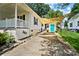 Long driveway leading to detached garage featuring shade sail, garden area, and turquoise garage door at 805 Caldwell St, Belmont, NC 28012