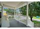 Covered porch with white railing and gray wood deck features views of the lawn and street at 805 Caldwell St, Belmont, NC 28012
