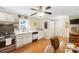 Well-lit kitchen features white cabinetry, stainless steel appliances, and wood flooring at 805 Caldwell St, Belmont, NC 28012