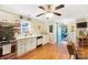 Well-lit kitchen features white cabinetry, stainless steel appliances, and wood flooring at 805 Caldwell St, Belmont, NC 28012