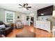 Cozy living room with hardwood floors and a ceiling fan, ideal for relaxation at 805 Caldwell St, Belmont, NC 28012