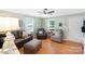 Well-lit living room featuring hardwood floors, ceiling fan, and a comfortable seating arrangement at 805 Caldwell St, Belmont, NC 28012