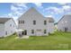 Home exterior showcasing a green lawn, gray siding, and a backyard patio set at 808 Dogwood Creek Ln, Indian Trail, NC 28079