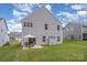 Backyard featuring a patio set, gray siding, and a lush green lawn at 808 Dogwood Creek Ln, Indian Trail, NC 28079