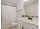 Bright bathroom with a shower and tub combo, white vanity, and modern finishes at 808 Dogwood Creek Ln, Indian Trail, NC 28079