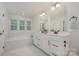 Bathroom featuring double sinks, modern fixtures, and a separate tub and shower at 808 Dogwood Creek Ln, Indian Trail, NC 28079