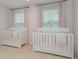 Bright bedroom features two cribs, neutral walls, carpet flooring, and natural light at 808 Dogwood Creek Ln, Indian Trail, NC 28079