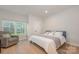 Cozy bedroom featuring a chair, queen-sized bed, and a window with a beautiful view at 808 Dogwood Creek Ln, Indian Trail, NC 28079