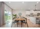 Open-concept dining area with a modern table set and a view of the backyard, connected to the kitchen at 808 Dogwood Creek Ln, Indian Trail, NC 28079