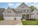 Beautiful two-story home boasts a three-car garage, welcoming front porch, and well-maintained lawn at 808 Dogwood Creek Ln, Indian Trail, NC 28079