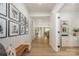 Spacious hallway with light wood floors, gallery wall, and seamless transition to open living spaces at 808 Dogwood Creek Ln, Indian Trail, NC 28079