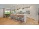 Bright kitchen with an island with bar seating and an adjacent dining area with a window view at 808 Dogwood Creek Ln, Indian Trail, NC 28079