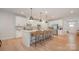 Bright kitchen features a large island with bar seating, stainless steel appliances, and modern white cabinetry at 808 Dogwood Creek Ln, Indian Trail, NC 28079