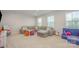 Spacious carpeted living room offers ample seating and natural light from large windows at 808 Dogwood Creek Ln, Indian Trail, NC 28079