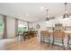 Open concept first floor features a dining table and a kitchen island with seating, great for entertaining at 808 Dogwood Creek Ln, Indian Trail, NC 28079
