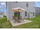 Back patio includes an outdoor table with an umbrella overlooking the lawn at 808 Dogwood Creek Ln, Indian Trail, NC 28079