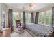 A bright bedroom with a bed and large windows overlooking a green landscape at 8119 Tremaine Ct # E, Charlotte, NC 28227