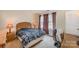 A comfortable bedroom with a bed, two side tables and a desk with chair near the window at 8119 Tremaine Ct # E, Charlotte, NC 28227
