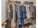 A walk-in closet with hanging clothes, shelves, and shoes neatly arranged at 8119 Tremaine Ct # E, Charlotte, NC 28227