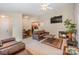 Spacious living room with a fireplace, TV, and a view into the dining area and kitchen at 8119 Tremaine Ct # E, Charlotte, NC 28227