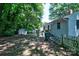 Expansive backyard featuring mature trees, a storage shed, and a partially fenced area, offering privacy and space at 828 Williams St, Gastonia, NC 28052