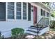 Inviting entrance with brick foundation, black shutters, and striking red front door at 828 Williams St, Gastonia, NC 28052
