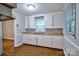 Bright kitchen featuring white cabinetry, a double sink, and ample natural light, perfect for cooking enthusiasts at 828 Williams St, Gastonia, NC 28052
